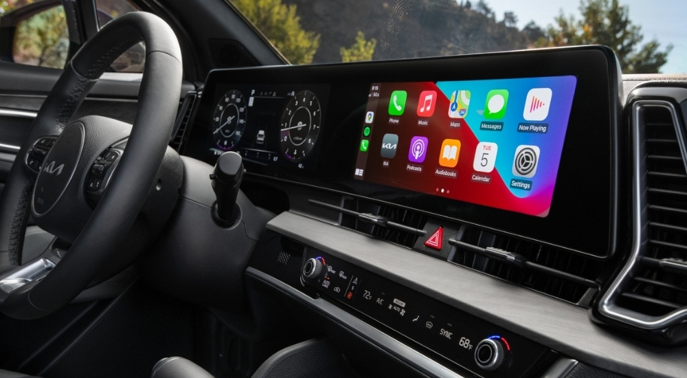 The dash of a 2025 Kia Sportage is shown from the passenger seat.