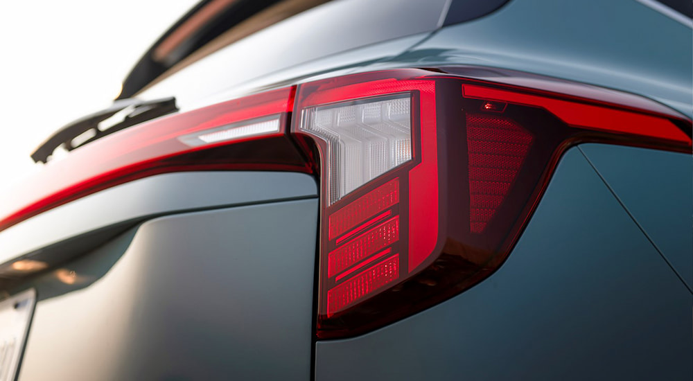 Close-up on the rear headlight of a green 2025 Kia Seltos.