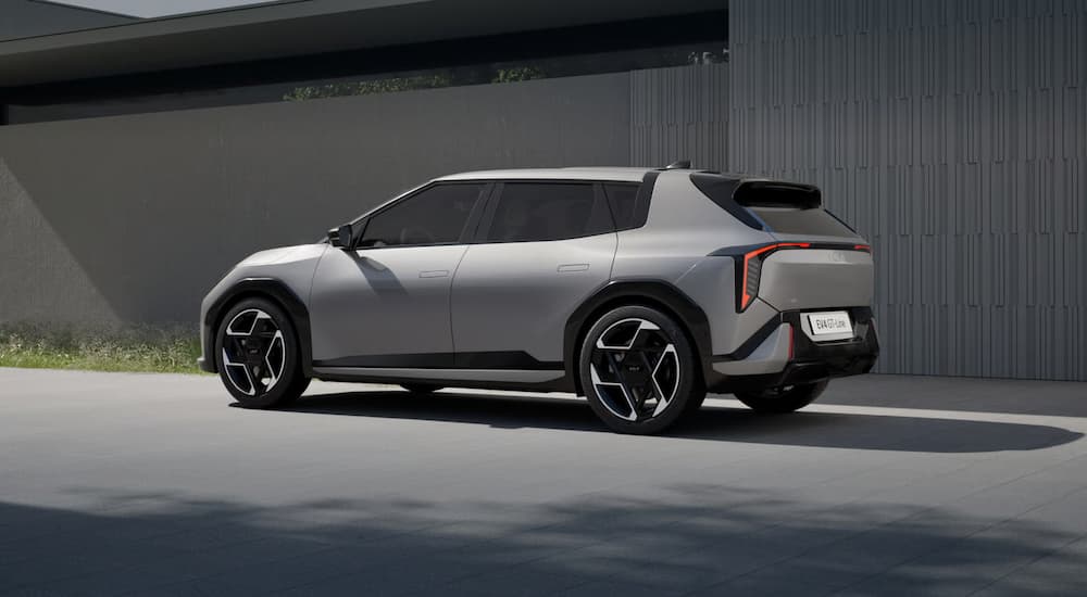 A gray 2026 Kia EV4 parked outside a building