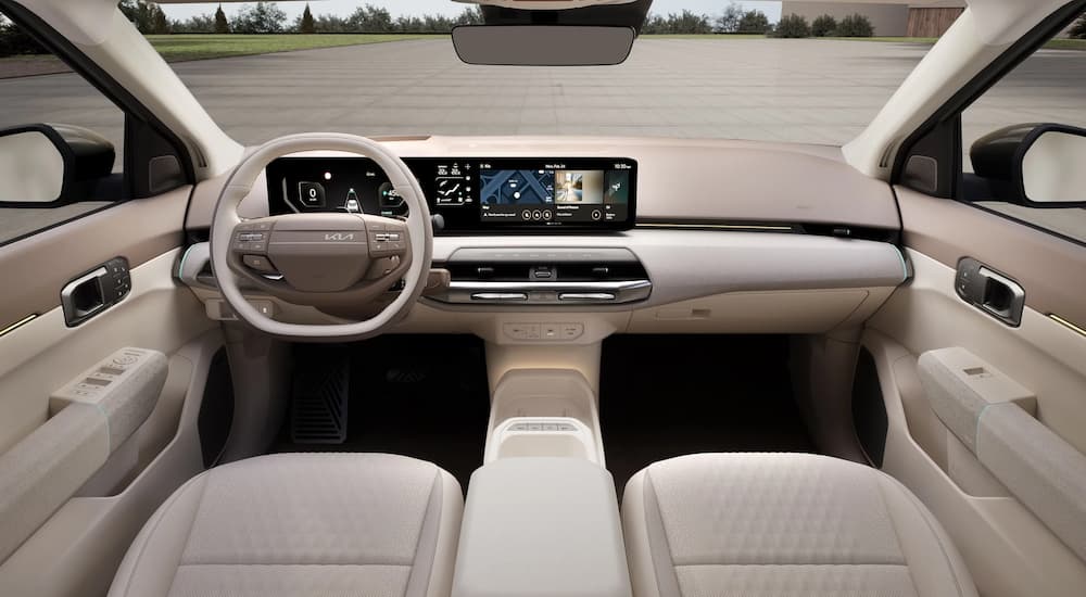 Infotainment display and digital gauge cluster on a 2026 Kia EV4 with cream colored interior
