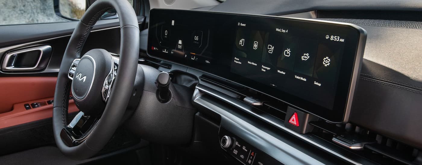 Steering wheel and dashboard in the interior of a 2026 Kia Carnival.