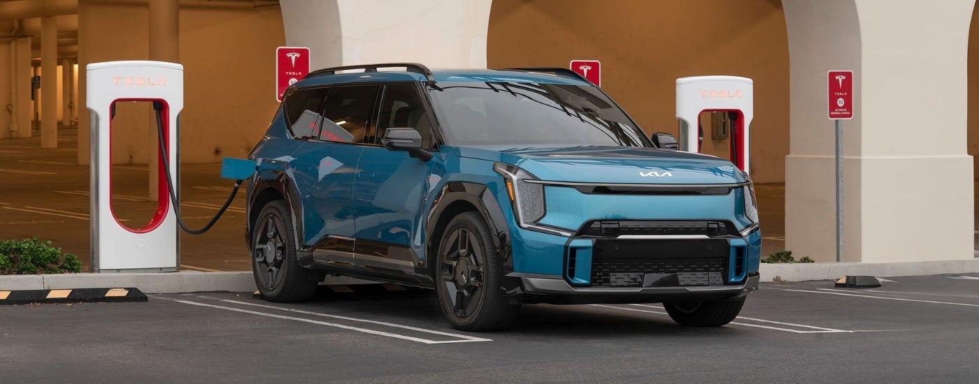 Blue 2026 Kia EV9 at a charging station