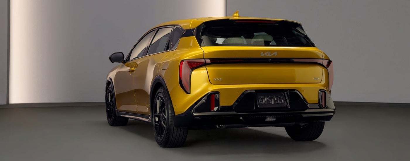 Yellow 2026 Kia K4 Hatchback GT parked in a showroom