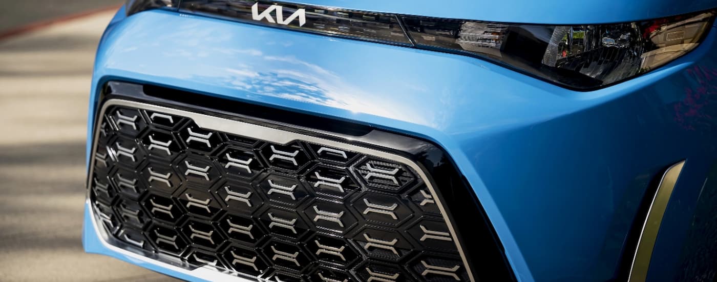 A close up of the grille of a blue 2024 Kia Soul at a Kia dealer near Addison.