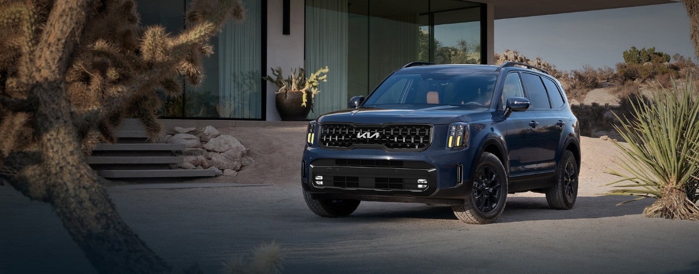 A black 2024 Kia Telluride parked outside a house after visiting a Kia dealer near Libertyville.